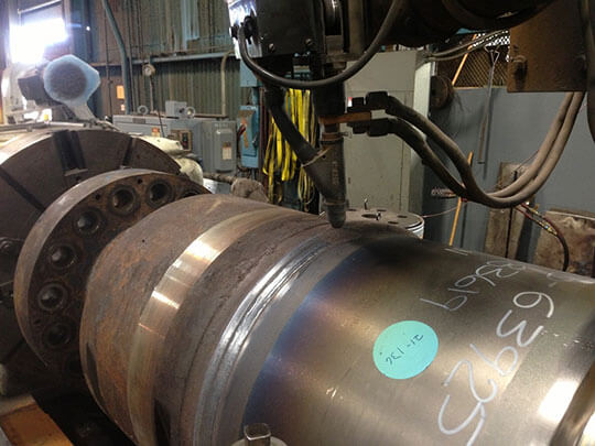 Weld lathe joining two coupling components.